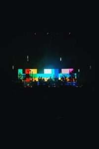 A live band in front of an LED screen