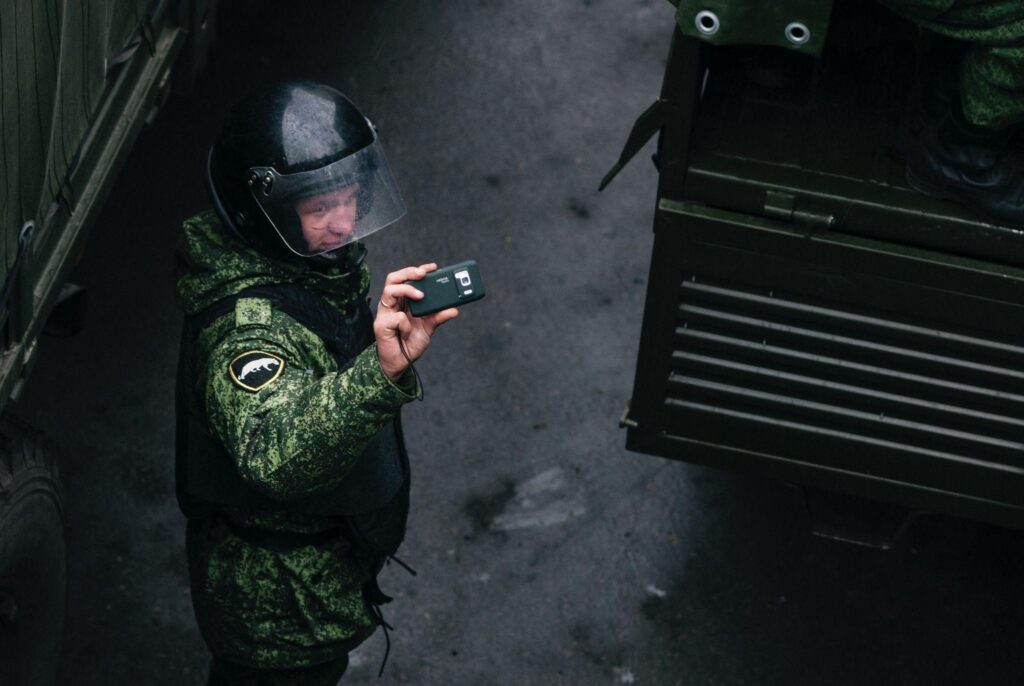 Person wearing a bulletproof vest working with a security system