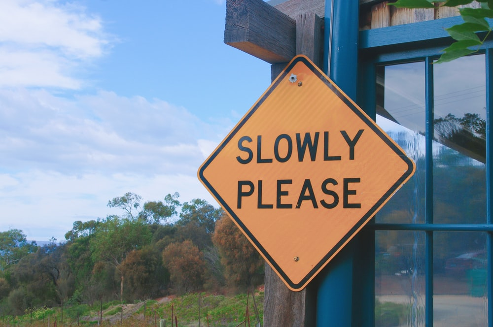 A safety sign reading “slowly please.”