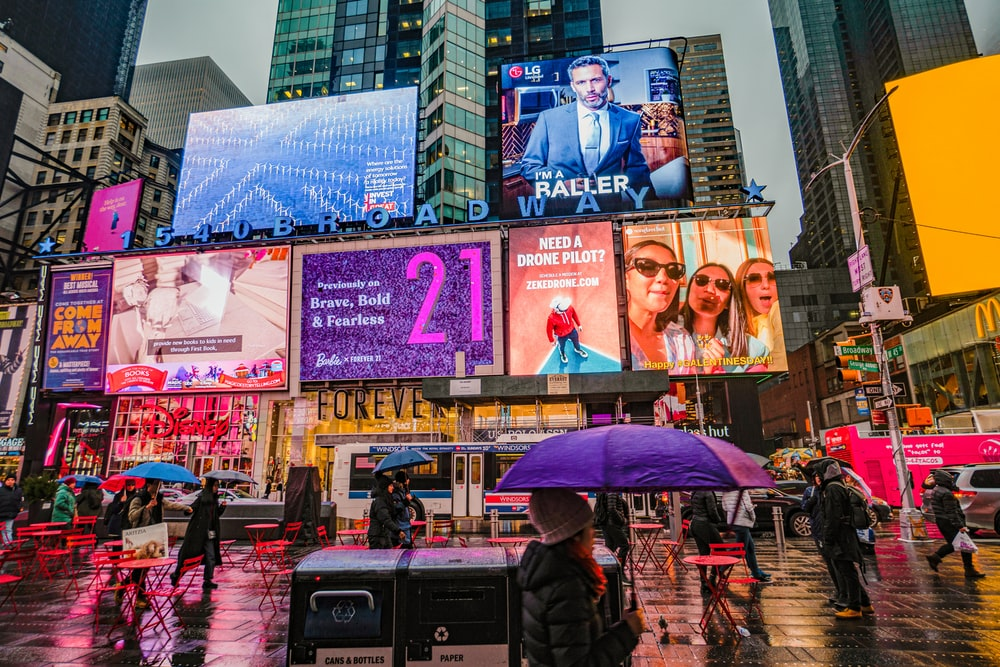 Several brand advertisements on LED billboards.