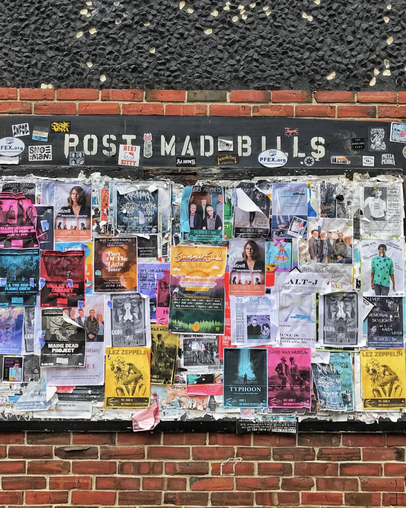 Posters on a brick wall