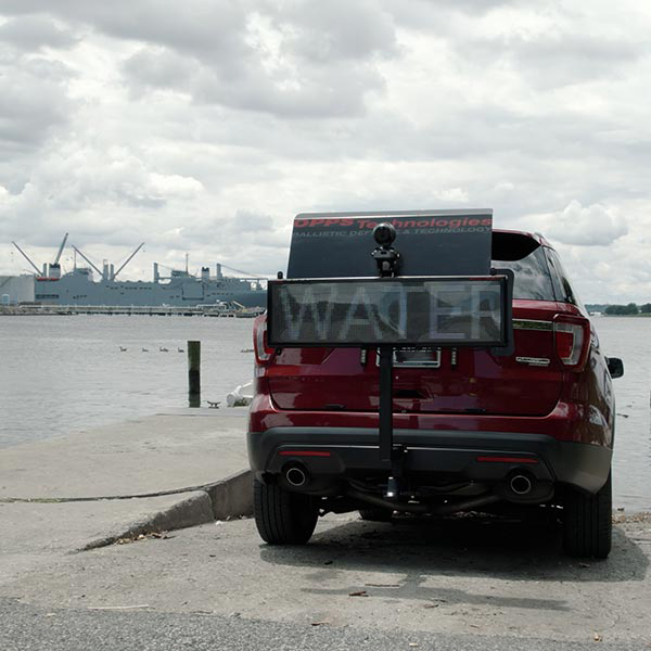 Car with VALIS 2 attachment parked next to a lake. 